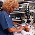 nurse looking after newborn baby