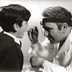 dentist examining boys mouth